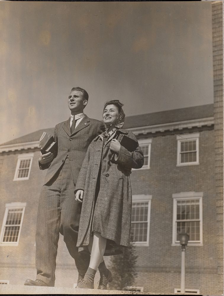 A smiling man and woman walk towards the camera by Arnold Eagle