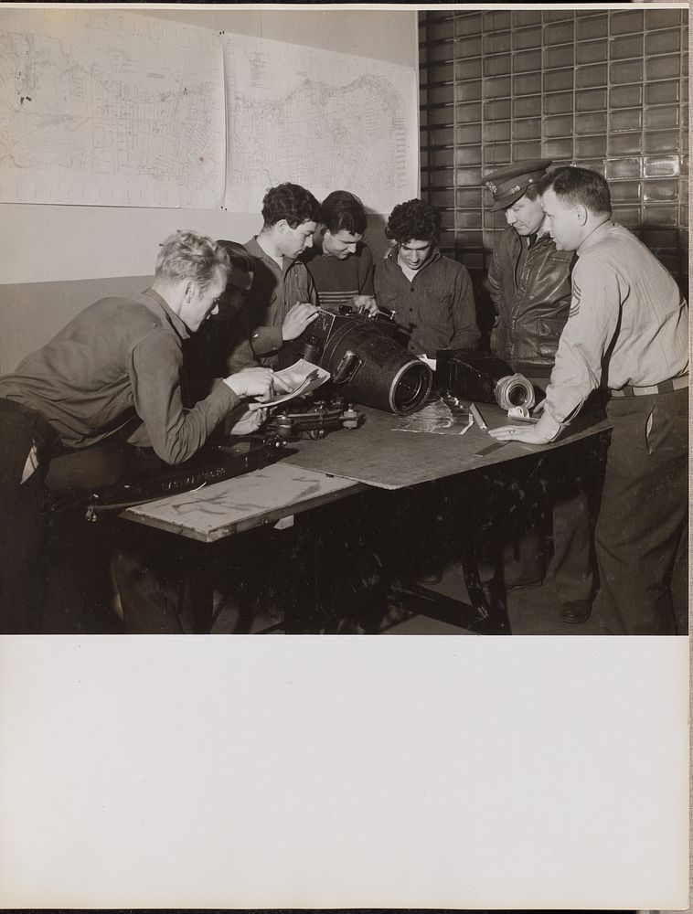 Six men inspect a large camera by Arnold Eagle