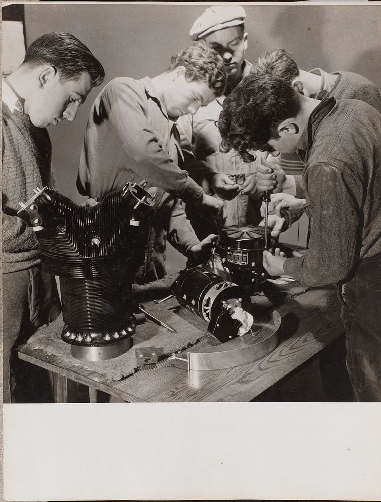 Five young men work around a work bench by Arnold Eagle