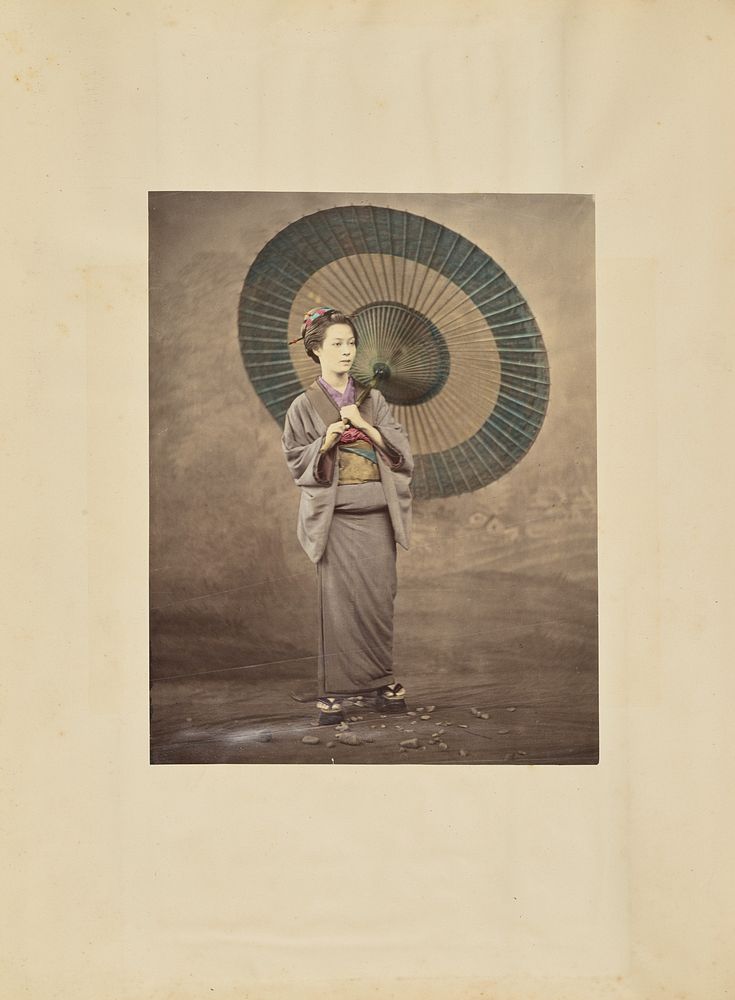 Japanese woman holding a large parasol by Felice Beato and Baron Raimund von Stillfried