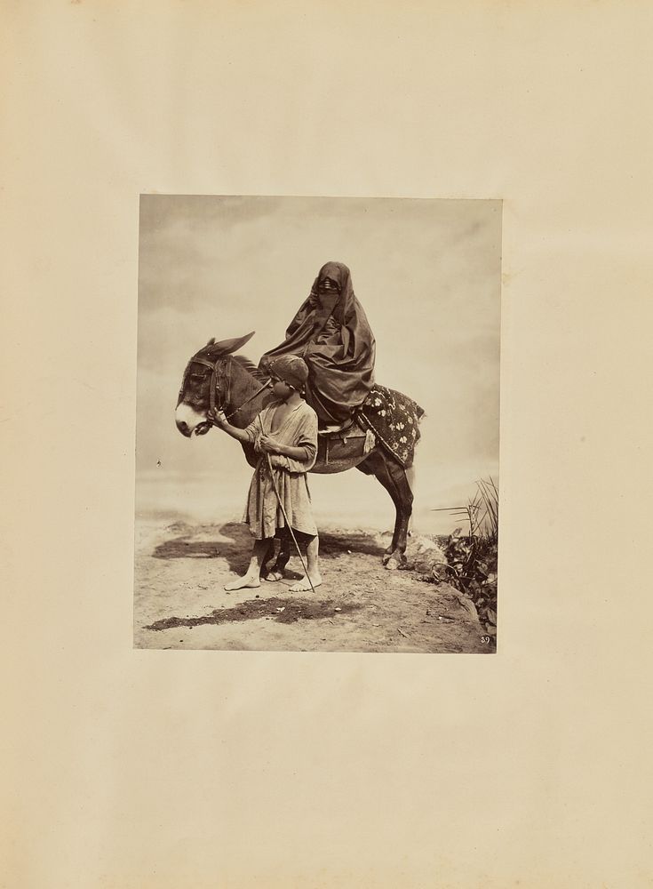 Veiled woman on donkey with boy by Carlo Naya
