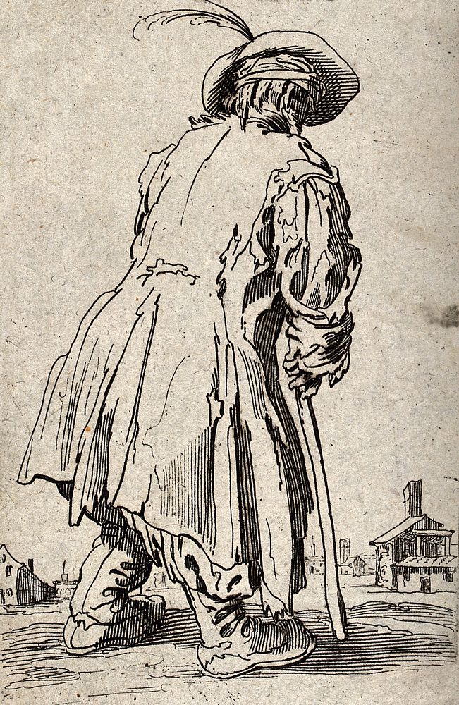 A beggar dressed in rags limping with the aid of a staff towards a village. Etching possibly after J. Callot.