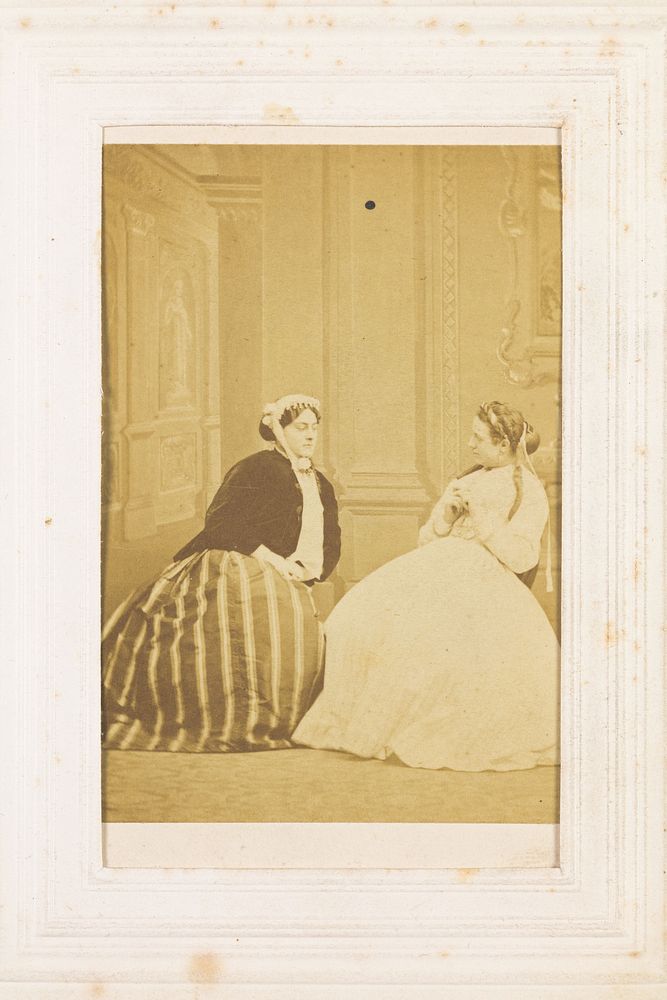 Two men in drag sitting in conversation. Photograph, 1855/1860.