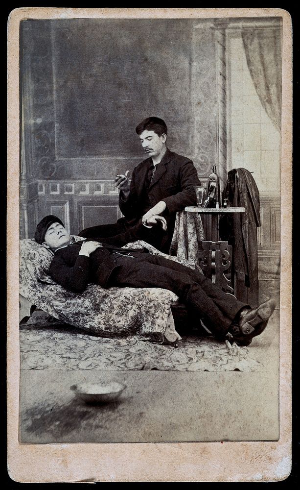 A man taking the pulse of another man. Albumen print.