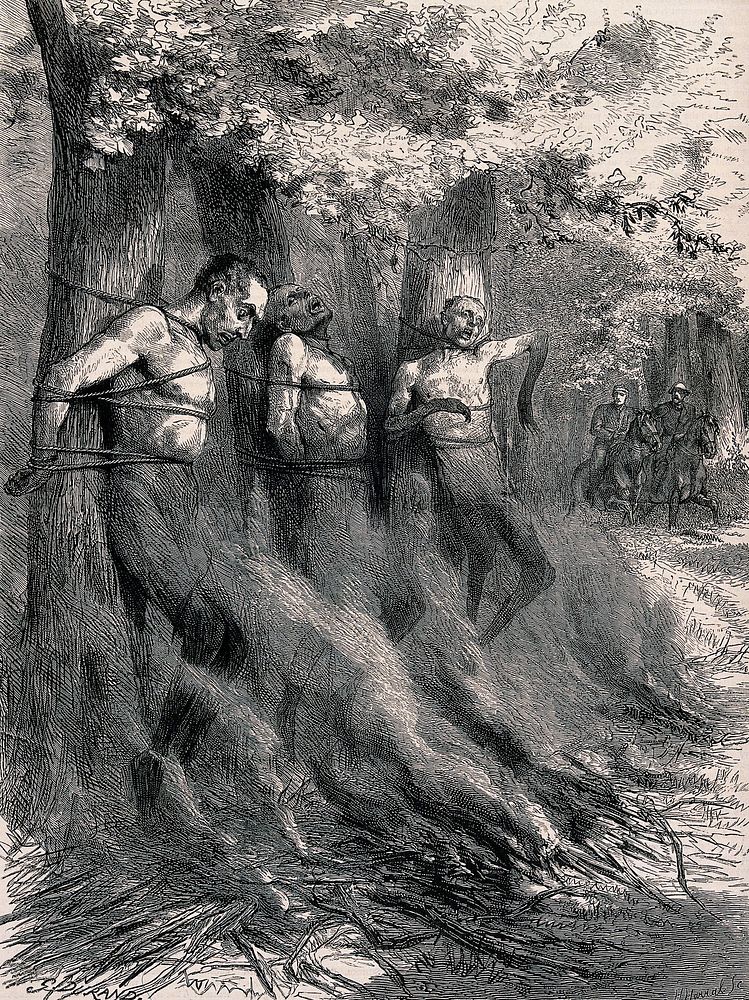 Three naked men are tied to trees with a bonfire set alight before them threatening to burn or asphyxiate them. Wood…