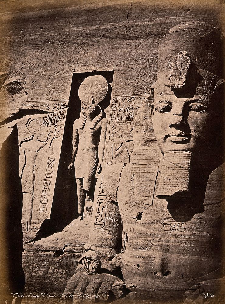 The Abou Simbel temple (the Sun Temple of Ramesses II), Nubia, Egypt: detail of facade showing Ramesses II and the sun god…