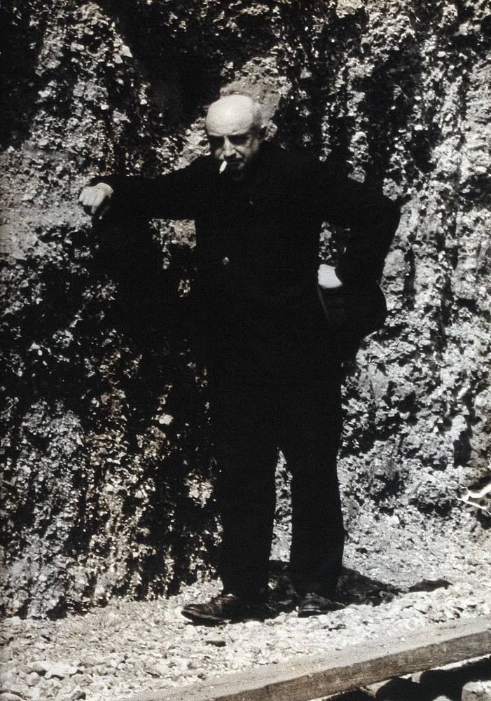 Abbé Breuil, smoking a cigarette. Photograph.