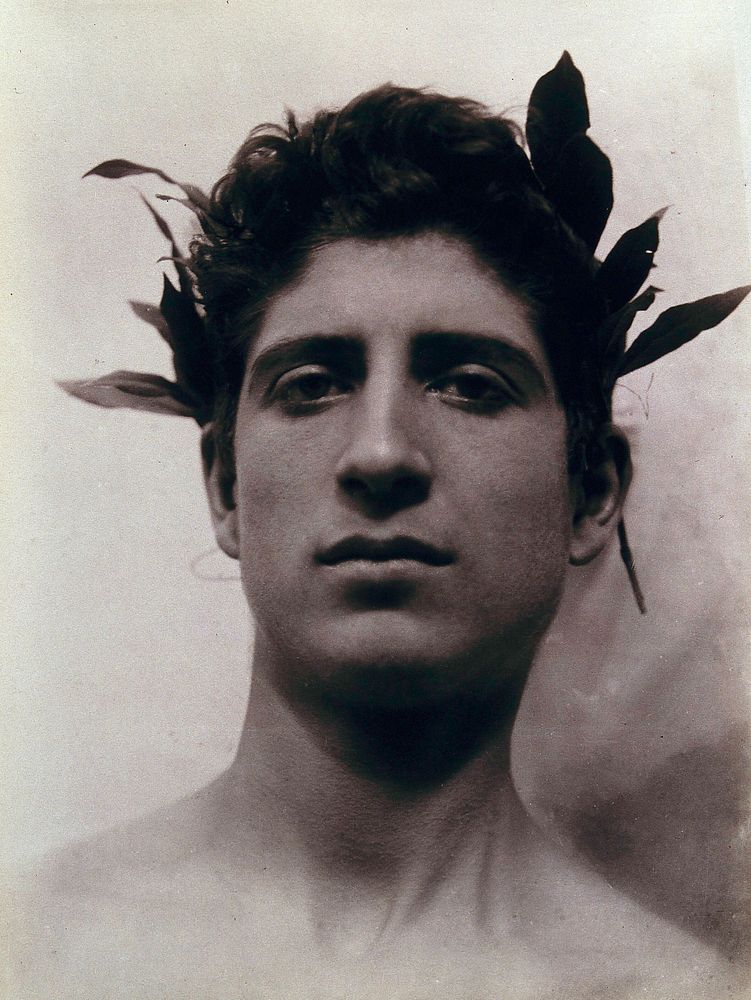 Head of a Sicilian boy posing, crowned with laurel leaves. Photograph by W. von Gloeden, 1902.