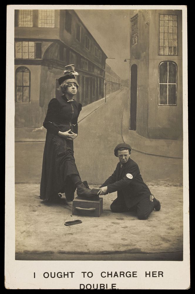 A shoeshine boy cleans the boots of a man in drag. Photographic postcard, ca. 1905.