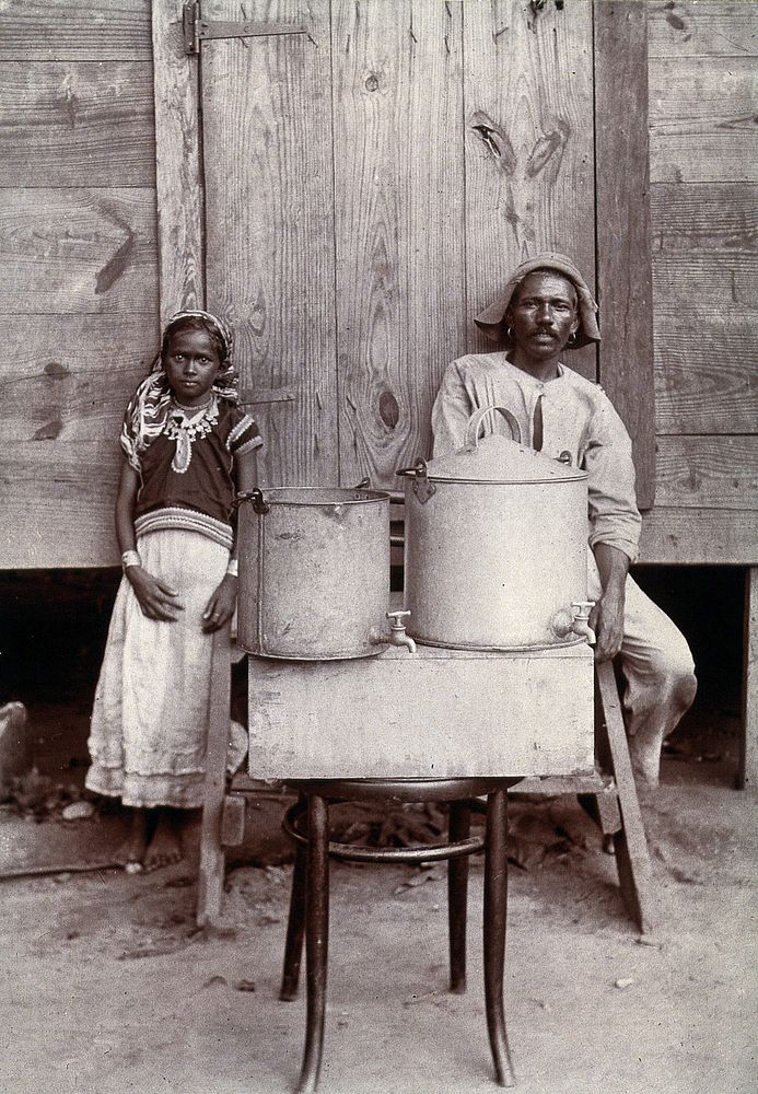 Milk pails - metal with small taps - with a man and girl in Trinidadian dress, Port of Spain, Trinidad. Photograph…