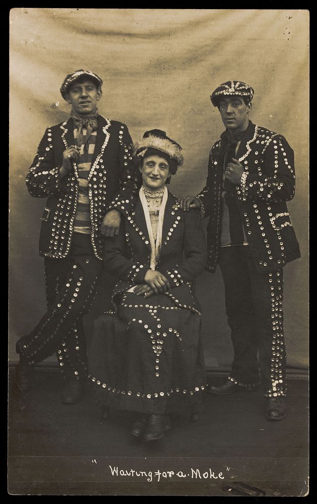 A drag pearly queen and her two kings pose for a group portrait. Photographic postcard, 191-.