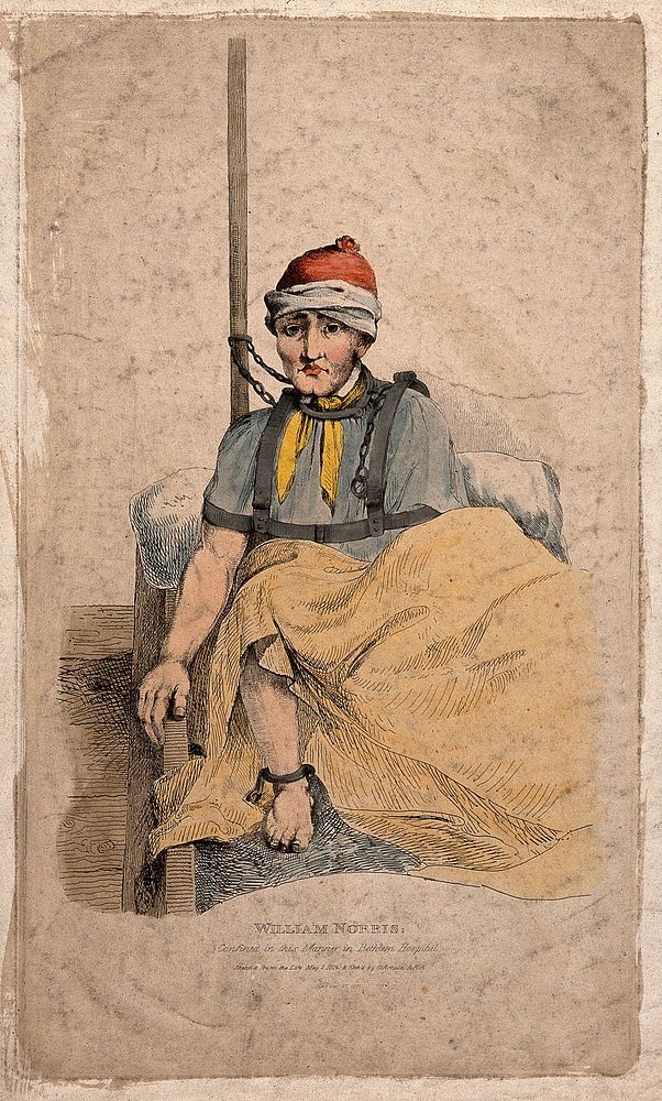 William Norris restrained by chains at the neck and ankles in Bethlem hospital, London. Coloured etching by G. Arnald, 1815…