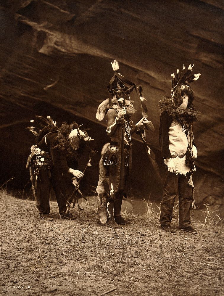 A 'Yebichai Sweat' Navajo medicine ceremony: three Navajos in ceremonial dress with faces masked. Photograph by Edward S.…