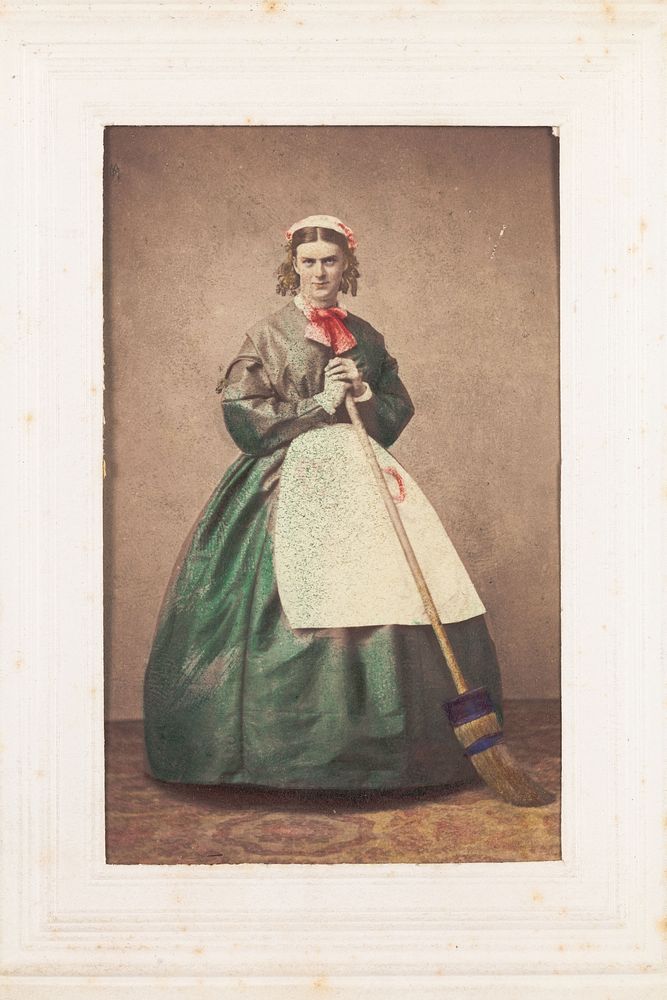 A man in drag holding a broom. Photograph, 1862.