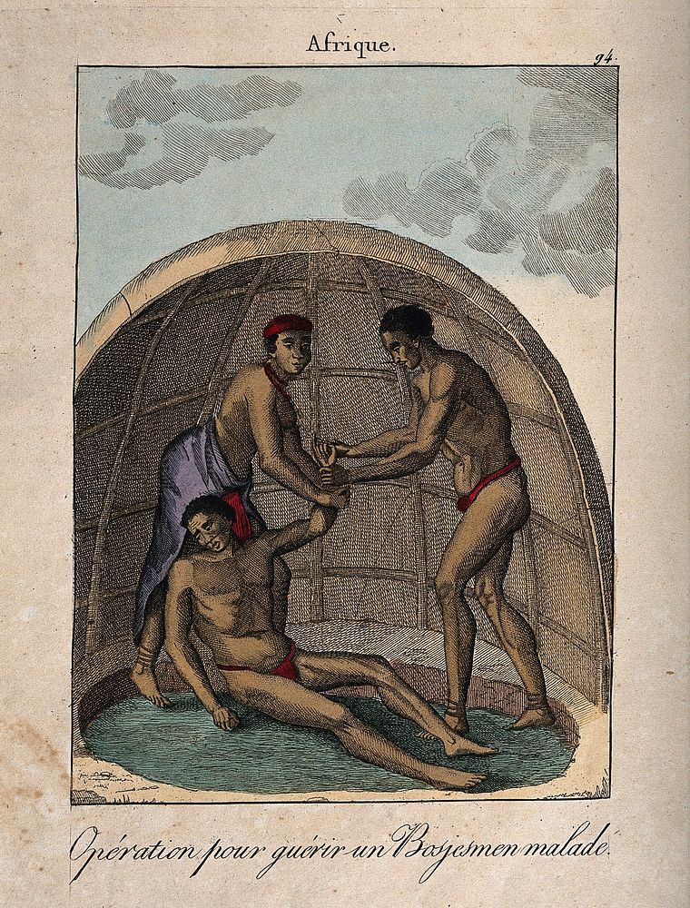 An African medicine man operating on a man's hand. Coloured engraving.