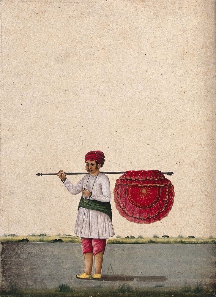 An Indian bearer holding a large, richly decorated fan or banner, horizontally on his shoulder. Watercolour by an Indian…