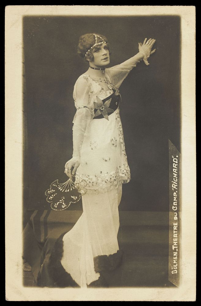 A French prisoner of war acting in an internment camp in Dülmen, performing in drag, wearing a long white dress.…