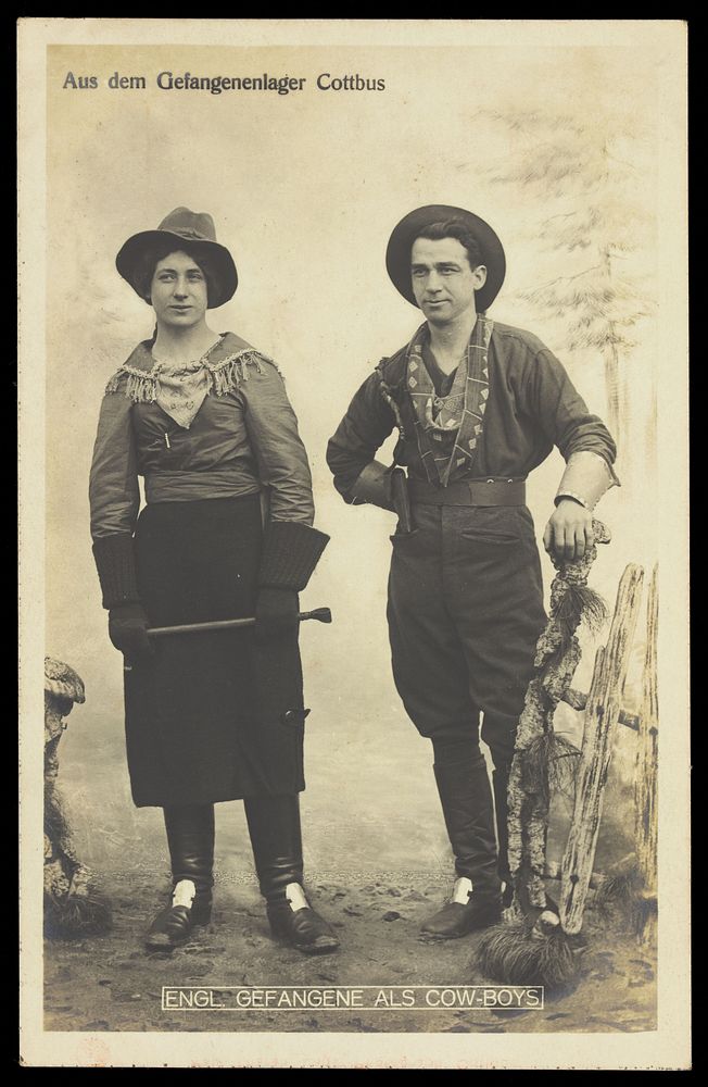 British prisoners of war in cowboy and cowgirl costumes posing at a prisoner of war camp in Cottbus. Photographic postcard…