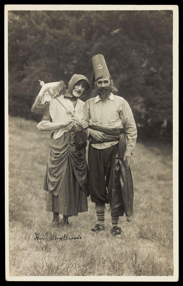 Harry Smallwood and another man stand in a field, one in drag and the other wearing Turkish inspired costume. Photographic…