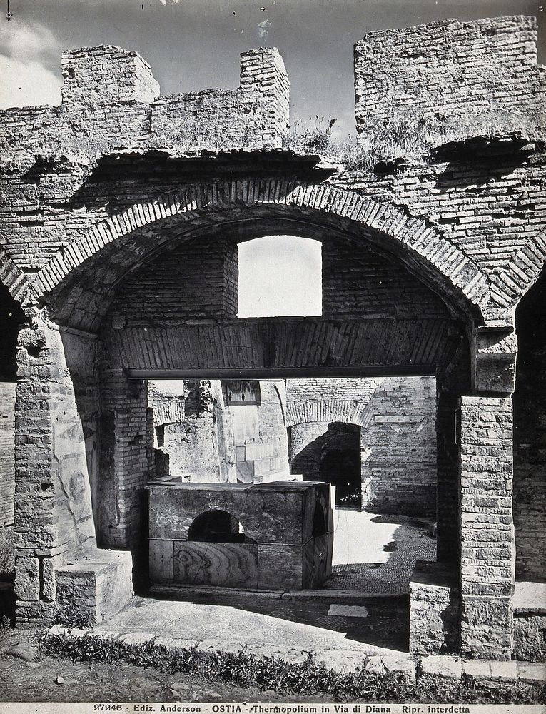 Partly ruined buildings in Ostia identified as a tavern or hot-food shop (thermopolium) from the 3rd century AD. Photograph…