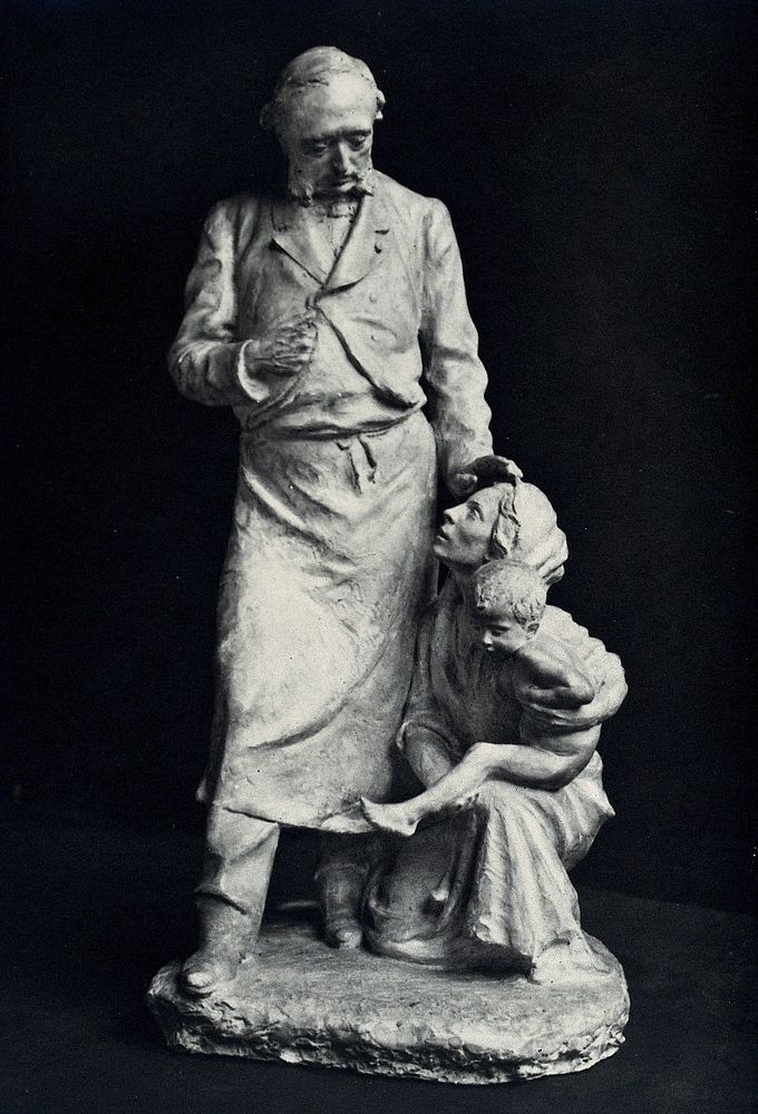 Léopold Ollier, an orthopaedic surgeon, comforting a woman holding a child kneeling at his feet. Photograph of a sculpture…
