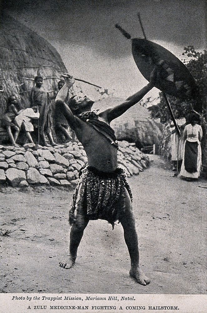 A Zulu medicine man or shaman performing a ritual to fend off a hailstorm, South Africa. Halftone after Trappist Mission…