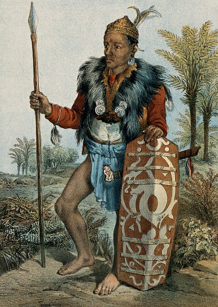 Borneo: a Dayak warrior, standing holding a spear and a shield. Coloured lithograph by C.F. Kell after Carl Bock.