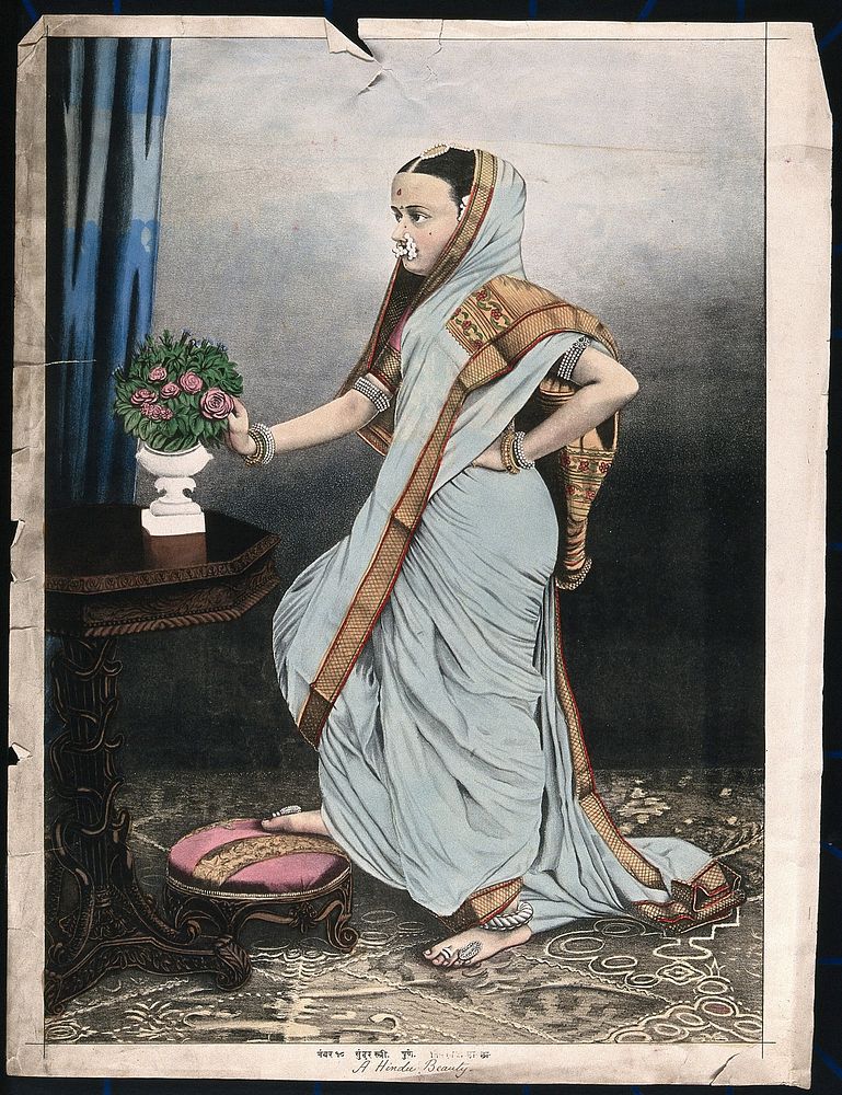 An Indian woman poses in front of a table on which is placed a vase of roses. Chromolithograph by an Indian artist,18--.