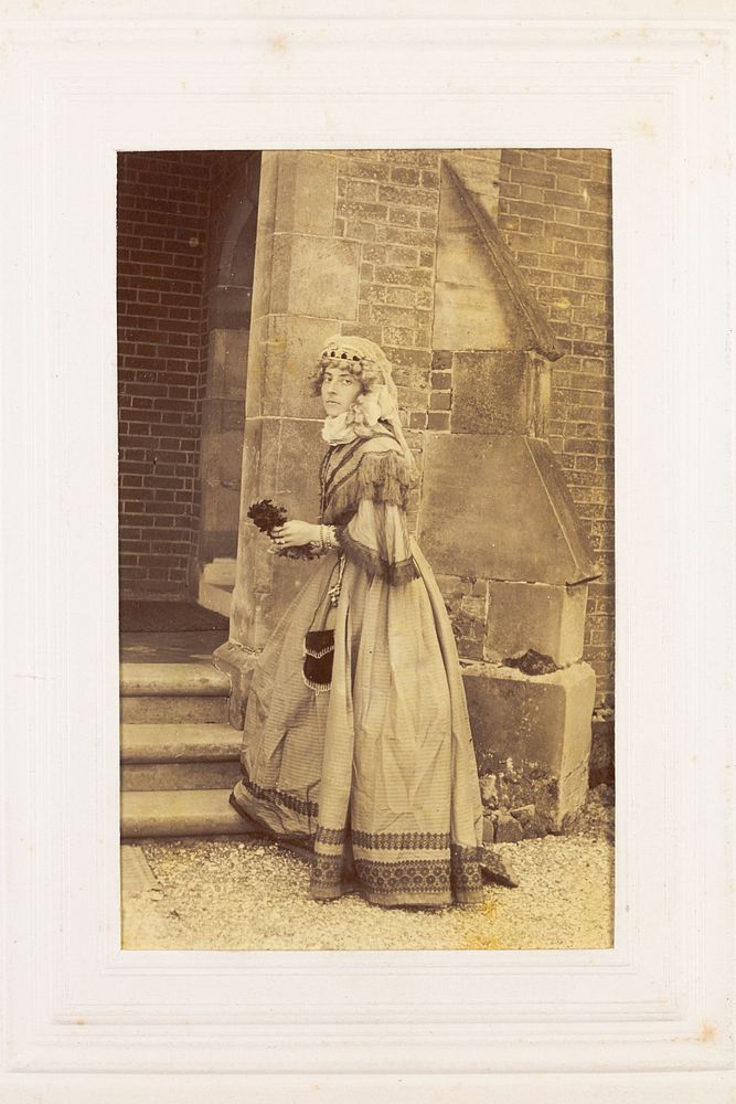 A man in drag posing in historical costume. Photograph, 189-.