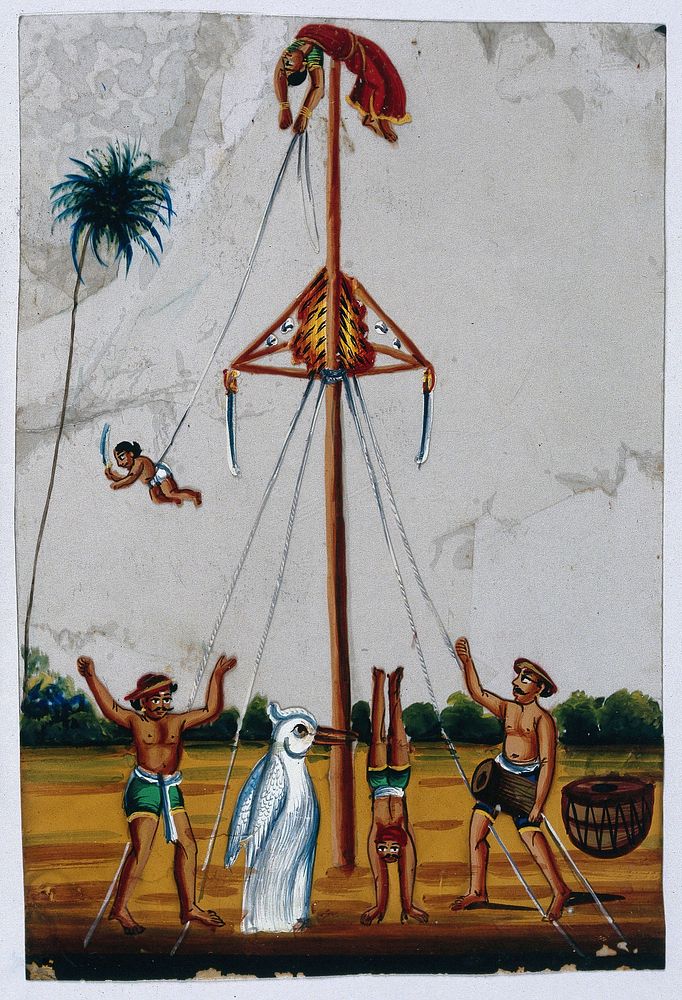Acrobats: a woman lying on top of a pole holding on to a boy tied to one end of a rope, while someone in a penguin costume…
