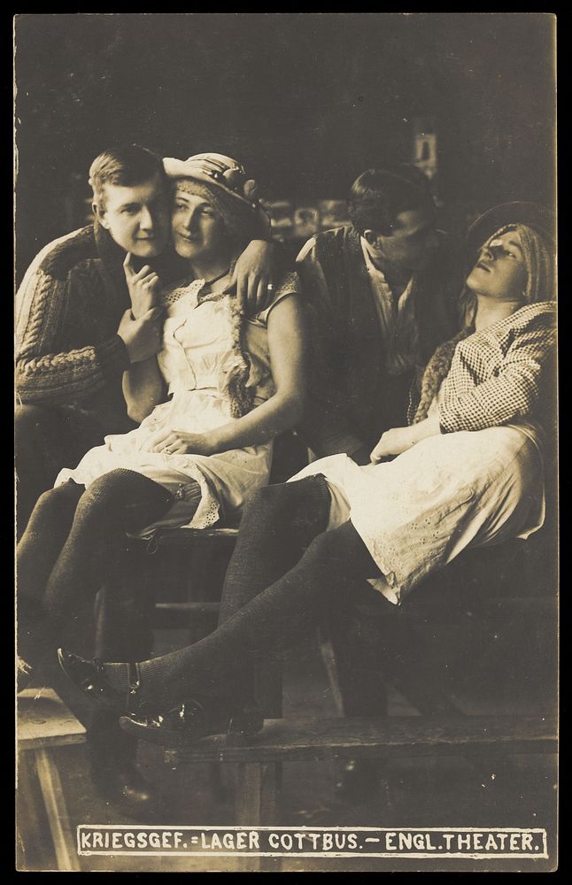 Four British prisoners of war at a prisoner of war camp in Cottbus, posing as lovers. Photographic postcard, 191-.