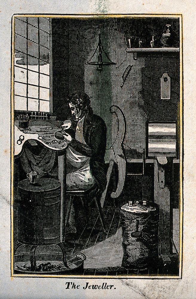 A man is sitting at a work bench making jewellery. Wood engraving.