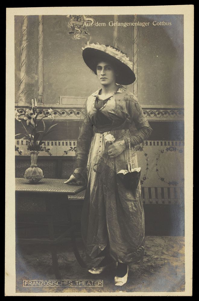A French prisoner of war posing in drag at a prisoner of war camp in Cottbus. Photographic postcard by P. Tharan, 191-.