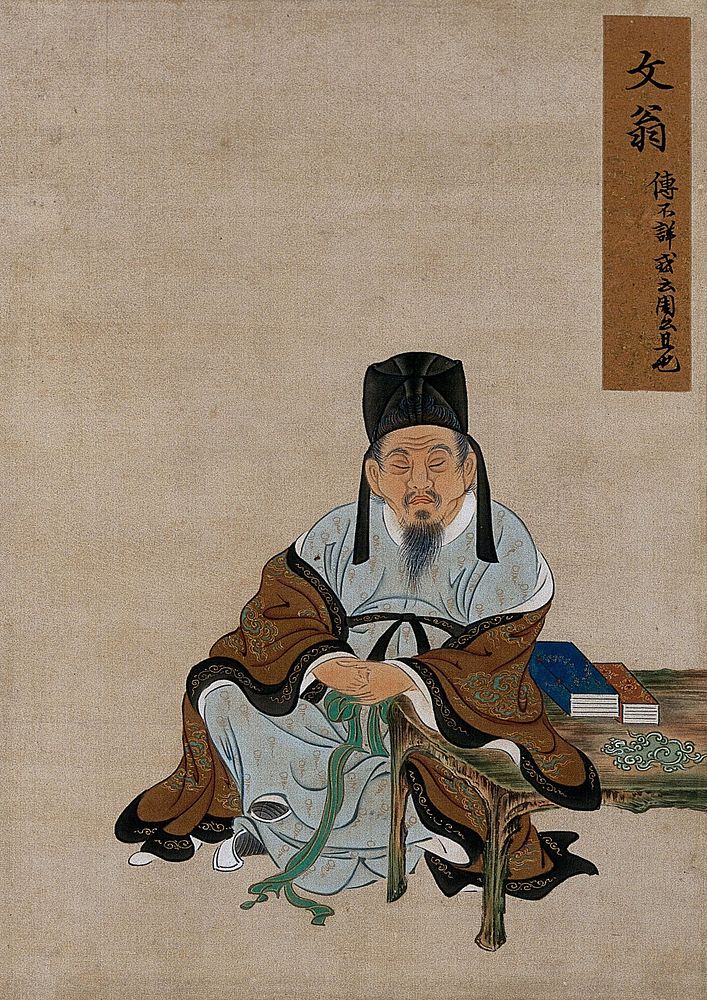 A Chinese figure, seated, with arm resting on a table with books; wearing brown and pale blue robes and tall black hat.…