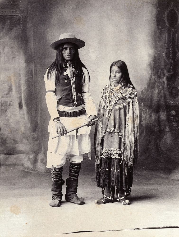A native American man and woman. Platinum print by F.A. Rinehart, 1898.