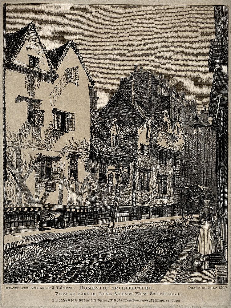The Church of St. Bartholomew the Great and surrounding area; a view of Duke Street in West Smithfield, where a woman walks…