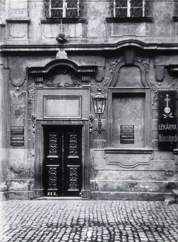 An ornate doorway into a large stone building used as a dispensary in Prague. Photograph by Z. Reach.