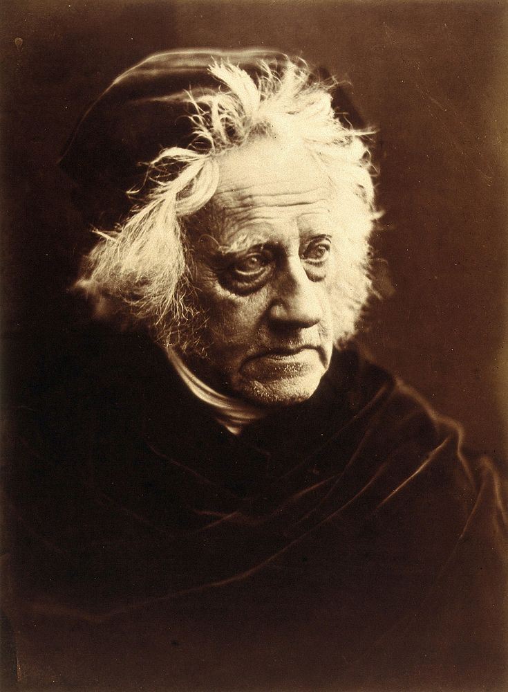 Sir John Herschel: wearing a cap and cape. Photograph by Julia Margaret Cameron, 1867.