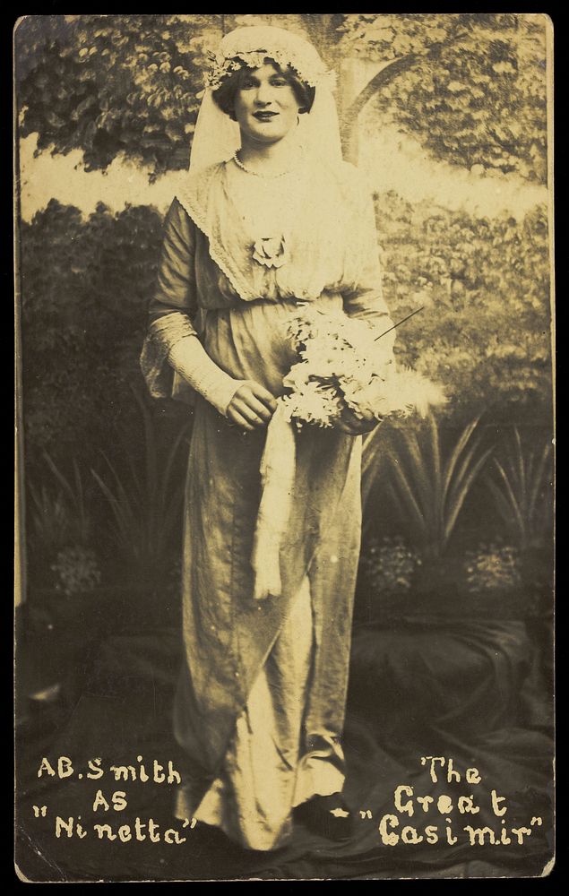 A sailor on H.M.S St. Vincent, in drag as a bride in a performance of 'The Great Casimir'. Photographic postcard, 1918.