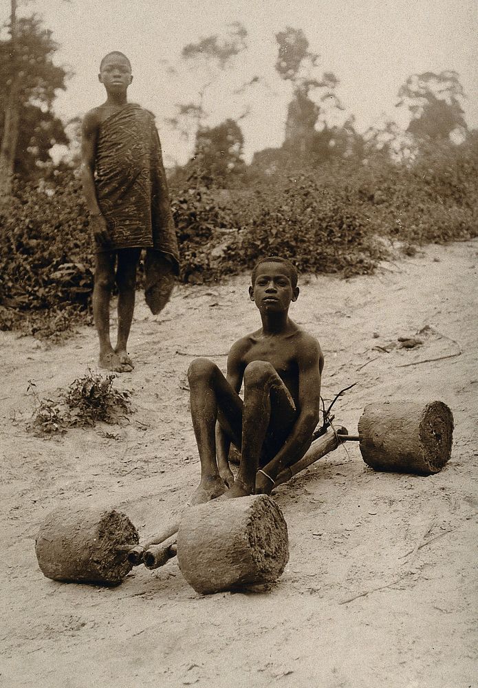 Ivory Coast: a boy with a handmade scooter. Photograph, 1910/1930 .