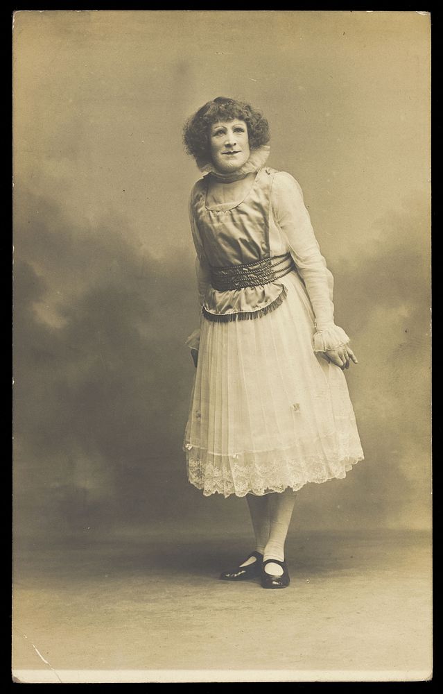 An actor in pantomime drag. Photographic postcard by Hana Studios, 190-.