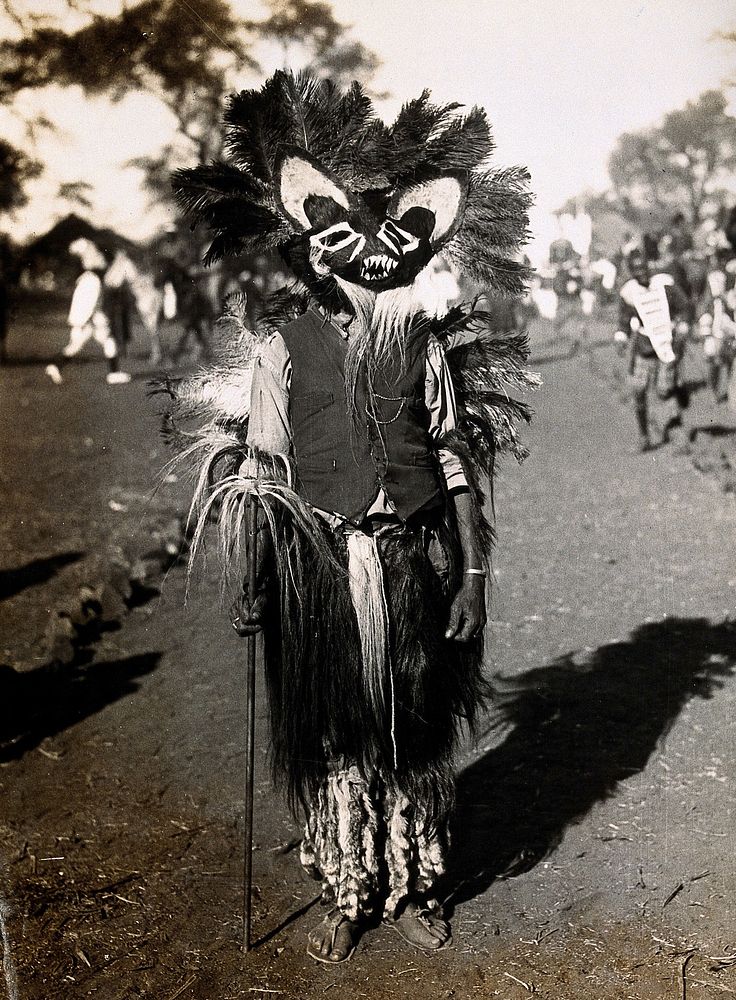 Serowe, Botswana: an African devil dancer wearing a headdress. Albumen print.