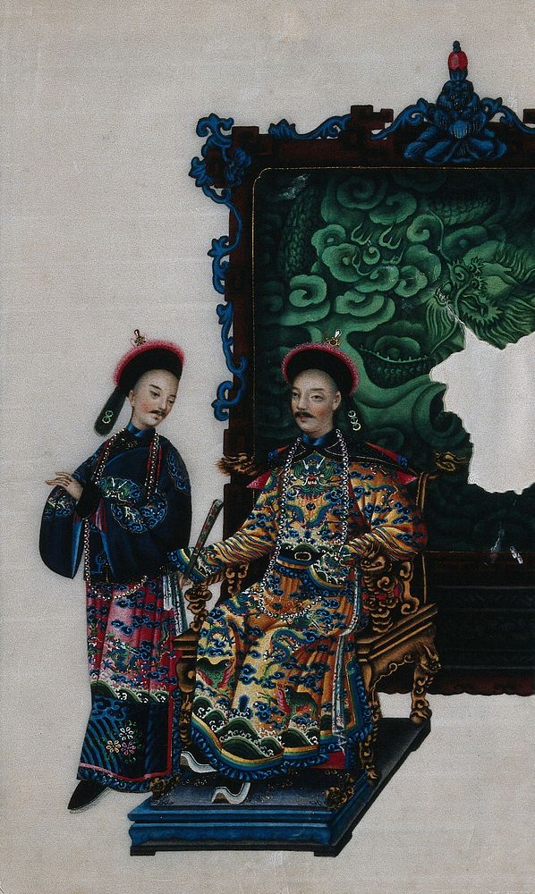 A high ranking Chinese official, seated on a double-headed dragon chair, with attendant, both dressed in richly patterned…