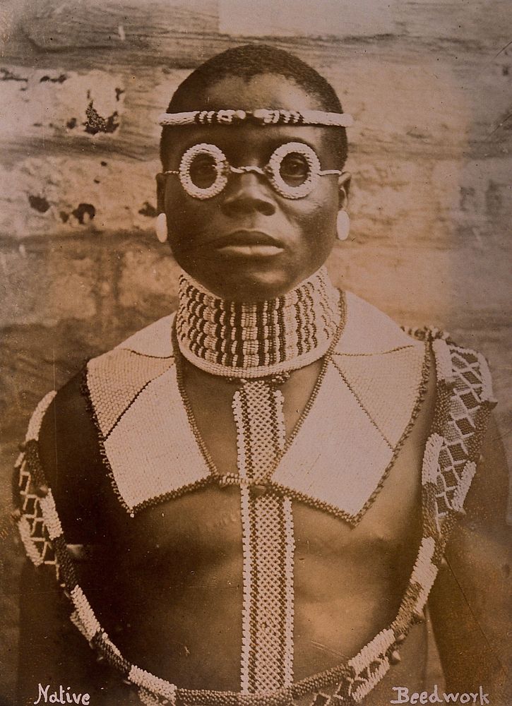 An African man wearing traditional beadwork. Albumen print.