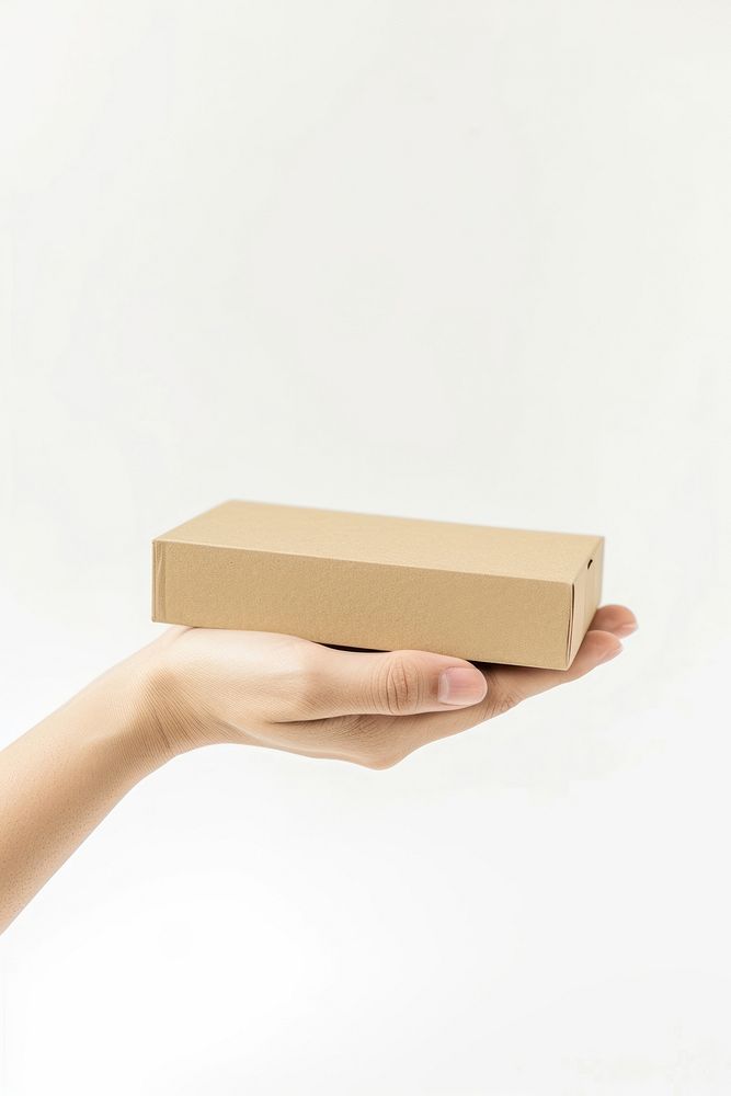 Hand hold beige flat card box cardboard carton white background.