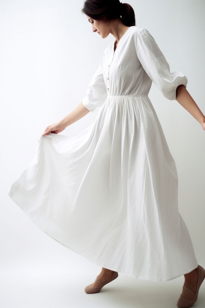 Woman wearing blank white smocked-waist textured dress fashion adult gown.