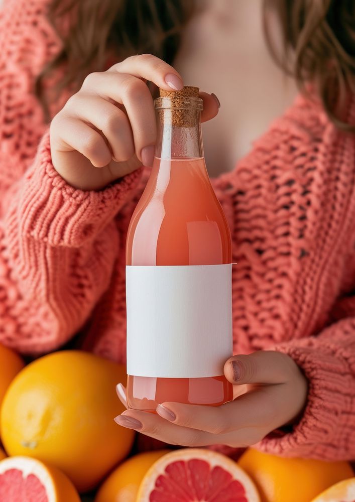 Woman holding a bottle of grapefruit juice food refreshment antioxidant.