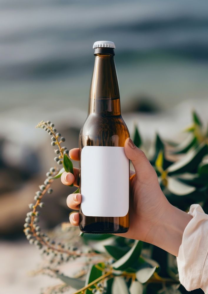 Woman holding a bottle of beer drink refreshment container.