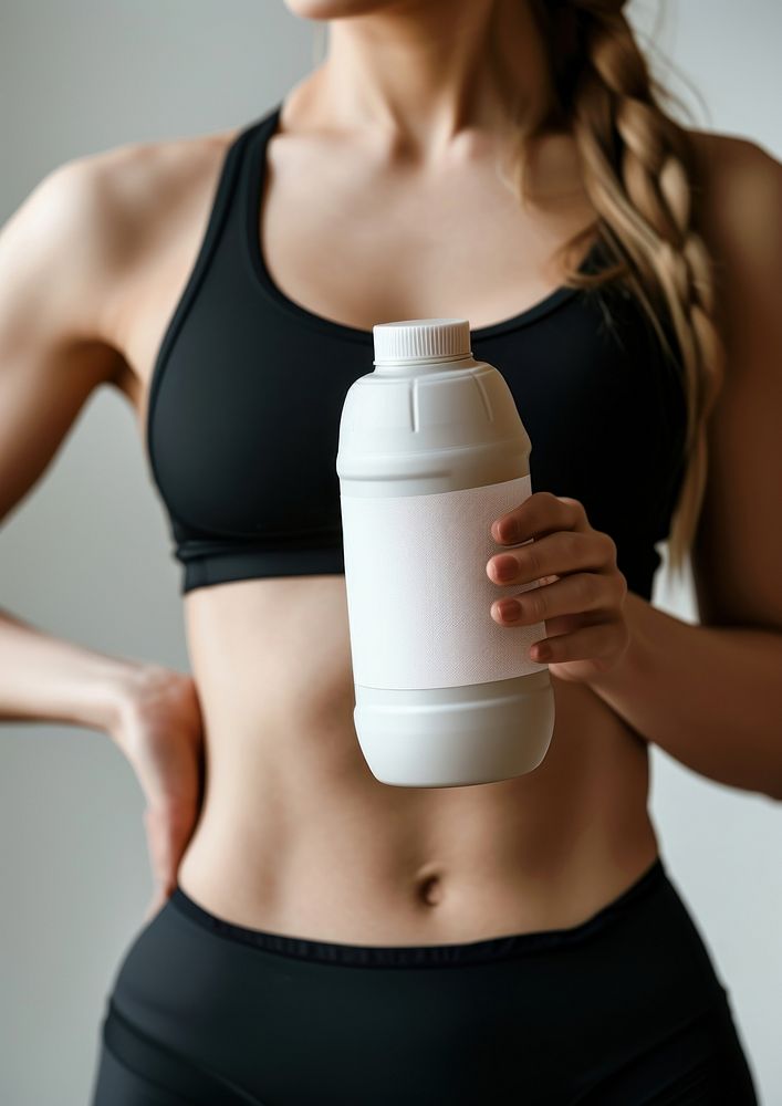 Woman holding a bottle of protein shaker determination refreshment exercising.