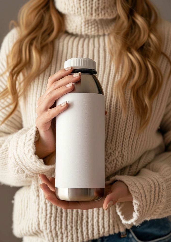 Woman holding a bottle of thermos refreshment medication container.
